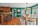 Open-concept view of the dining room and kitchen with hardwood floors and ample natural light at 5270 Forest Brook Pkwy, Marietta, GA 30068
