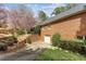 Brick home featuring a two-car garage, lush landscaping, and a beautiful magnolia tree in the front yard at 5270 Forest Brook Pkwy, Marietta, GA 30068