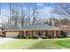 Charming brick home featuring a well-maintained lawn, two-car garage, and mature landscaping at 5270 Forest Brook Pkwy, Marietta, GA 30068