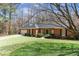 Quaint brick home featuring manicured lawn and front-facing two-car garage at 5270 Forest Brook Pkwy, Marietta, GA 30068
