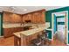 Well-lit kitchen featuring wood cabinetry, granite countertops, and a breakfast bar with stool seating at 5270 Forest Brook Pkwy, Marietta, GA 30068