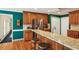 Bright kitchen featuring stainless steel refrigerator, breakfast bar with seating, and hardwood floors at 5270 Forest Brook Pkwy, Marietta, GA 30068
