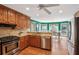 Traditional kitchen featuring wood cabinets, stone countertops, stainless steel appliances, and a view to the eat-in nook at 5270 Forest Brook Pkwy, Marietta, GA 30068