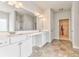 Bright bathroom with double vanity, tub, tiled floor, and walk-in closet access at 101 Wins Walk, Cartersville, GA 30121