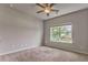 Neutral bedroom with carpet flooring, a window view, and a ceiling fan at 101 Wins Walk, Cartersville, GA 30121
