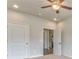 Bedroom with a ceiling fan, neutral paint, and a view of connecting rooms with open doorways at 101 Wins Walk, Cartersville, GA 30121
