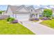 Single-story gray home with a manicured lawn, an attached garage, and lovely landscaping at 101 Wins Walk, Cartersville, GA 30121