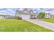 Charming home with a manicured front yard, lush landscaping, and a welcoming driveway at 101 Wins Walk, Cartersville, GA 30121