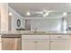 Granite island with a sink and a stainless steel dishwasher, with kitchen cabinets and appliances visible at 101 Wins Walk, Cartersville, GA 30121