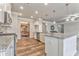 Kitchen with granite countertops, stainless appliances, island sink, and a view into dining and living areas at 101 Wins Walk, Cartersville, GA 30121