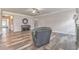 Spacious living room with wood flooring, a ceiling fan, and a cozy armchair at 101 Wins Walk, Cartersville, GA 30121