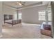 Expansive main bedroom boasts tray ceilings, plush carpet, and large windows, offering ample natural light at 101 Wins Walk, Cartersville, GA 30121