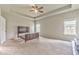 Large main bedroom with tray ceilings, plush carpet, and bright windows, offering a tranquil retreat at 101 Wins Walk, Cartersville, GA 30121
