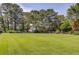 Expansive backyard with lush green lawn and mature trees providing a serene and private outdoor space at 1292 Green Turf Dr, Snellville, GA 30078