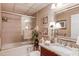 Well-lit bathroom with granite countertops, framed mirrors, and a shower-tub combination at 1292 Green Turf Dr, Snellville, GA 30078