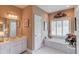Bathroom features a soaking tub, shower, framed art, and a sink with vanity at 1292 Green Turf Dr, Snellville, GA 30078