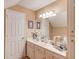 Bright bathroom featuring a large mirror, vanity with sink, neutral tones, and decorative accents at 1292 Green Turf Dr, Snellville, GA 30078