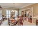 Elegant dining room featuring a large table set for a meal, bright windows, and classic decor at 1292 Green Turf Dr, Snellville, GA 30078