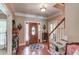 Welcoming foyer with hardwood floors, staircase, and elegant decor leading into the home's interior at 1292 Green Turf Dr, Snellville, GA 30078