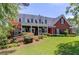 Inviting two-story brick home with a covered porch and beautifully landscaped front yard at 1292 Green Turf Dr, Snellville, GA 30078