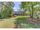 Beautiful brick home with a manicured lawn and mature trees providing shade and curb appeal at 1292 Green Turf Dr, Snellville, GA 30078