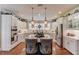 Kitchen area with white cabinets, granite countertops, and a central island with hanging lights at 1292 Green Turf Dr, Snellville, GA 30078