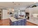 Kitchen island featuring a cooktop, with white cabinets and stainless steel appliances at 1292 Green Turf Dr, Snellville, GA 30078