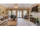 Spacious living room featuring a fireplace, comfortable seating, and doors leading to the outdoor area at 1292 Green Turf Dr, Snellville, GA 30078