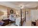 Bedroom features a four poster bed, floral decor, and ceiling fan at 1292 Green Turf Dr, Snellville, GA 30078