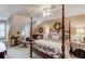 Bedroom features a four poster bed, ceiling fan, and cozy sitting area at 1292 Green Turf Dr, Snellville, GA 30078