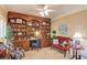 Office with custom built-in shelves, decor, ceiling fan, and comfortable seating at 1292 Green Turf Dr, Snellville, GA 30078