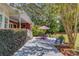Beautiful backyard patio with outdoor seating, lush greenery, and picturesque views of mature trees and the garden at 1292 Green Turf Dr, Snellville, GA 30078