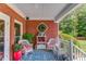 Inviting porch featuring comfortable seating, brick accents, and a relaxing outdoor space at 1292 Green Turf Dr, Snellville, GA 30078