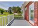 Charming porch view with painted wood floors, white railing, and views of the beautiful, green backyard at 1292 Green Turf Dr, Snellville, GA 30078