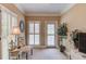 Cozy sitting room featuring shuttered windows, neutral walls, and a decorative mirror at 1292 Green Turf Dr, Snellville, GA 30078
