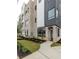 Modern home displaying clean lines, gray brick, black window frames, and lush landscaping at 1962 8Th St, Chamblee, GA 30341