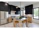 Modern kitchen featuring stainless steel appliances, a gray island with seating, contrasting cabinet colors and modern lighting at 1962 8Th St, Chamblee, GA 30341