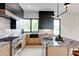 Modern kitchen with stainless steel appliances, island with marble countertop, and wooden lower and black upper cabinets at 1962 8Th St, Chamblee, GA 30341