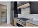 Modern kitchen features stainless steel appliances, granite countertops, and custom black and wood cabinetry at 1962 8Th St, Chamblee, GA 30341