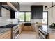Bright kitchen with granite countertops, stainless steel appliances, a window and modern black and wood cabinets at 1962 8Th St, Chamblee, GA 30341