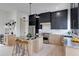 Sleek kitchen with stainless steel appliances, an island with counter seating, and wooden lower and black upper cabinets at 1962 8Th St, Chamblee, GA 30341