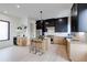 Stylish kitchen featuring an island with seating, modern stainless appliances, light wood lowers, and contrasting black uppers at 1962 8Th St, Chamblee, GA 30341