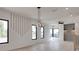 Spacious living room with contemporary lighting, wall accents, hardwood floors, and black-framed windows at 1962 8Th St, Chamblee, GA 30341