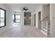 Open and airy living room featuring hardwood floors, black-framed windows, contemporary lighting, and staircase at 1962 8Th St, Chamblee, GA 30341
