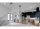 Open-concept living space with hardwood floors, modern lighting fixtures, and a stylish kitchen in the background at 1962 8Th St, Chamblee, GA 30341
