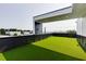 This stylish roof deck features artificial turf, offering a low-maintenance and attractive outdoor living space with city views at 1962 8Th St, Chamblee, GA 30341