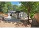 Landscaped backyard with a deck and gravel area, partial view of the home, and lush greenery at 2139 Cedarbrook Court South East, Atlanta, GA 30316
