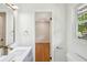 Clean bathroom featuring modern vanity with sink, window, and access to bedroom with hardwood floors at 2139 Cedarbrook Court South East, Atlanta, GA 30316