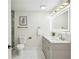 Modern bathroom featuring double sinks, a lighted mirror, and a walk-in shower at 2139 Cedarbrook Court South East, Atlanta, GA 30316
