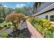 Eye-catching two-story home featuring a brick pathway and a beautifully landscaped yard with diverse plantings and greenery at 2139 Cedarbrook Court South East, Atlanta, GA 30316